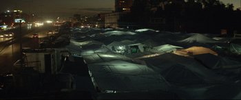 Movie still from “Capernaum” (2018), directed by Nadine Labaki – A bunch of tarps that are lit up at night; Extreme Wide shot, High angle