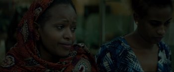 Movie still from “Capernaum” (2018), directed by Nadine Labaki – A person sitting on a couch; Close Up shot, Over the shoulder angle