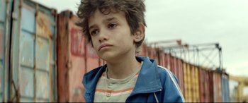 Movie still from “Capernaum” (2018), directed by Nadine Labaki – A young boy is looking at the camera; Close Up shot, Low angle