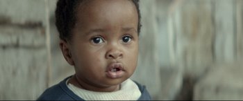 Movie still from “Capernaum” (2018), directed by Nadine Labaki – A child with a mouth open; Close Up shot, Low angle