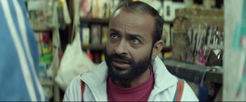 Movie still from “Capernaum” (2018), directed by Nadine Labaki – A man with a goatee and a beard looking up; Close Up shot, Over the shoulder angle