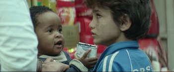 Movie still from “Capernaum” (2018), directed by Nadine Labaki – A young boy holding an object in his hands; Close Up shot, Over the shoulder angle