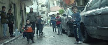 Movie still from “Capernaum” (2018), directed by Nadine Labaki – A group of children standing on the side of a road; Wide shot, High angle