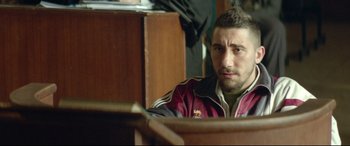 Movie still from “Capernaum” (2018), directed by Nadine Labaki – A person sitting at a table; Close Up shot, Over the shoulder angle