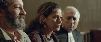 Movie still from “Capernaum” (2018), directed by Nadine Labaki – An older man and a younger woman sitting next to each other; Close Up shot, Over the shoulder angle