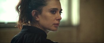 Movie still from “Capernaum” (2018), directed by Nadine Labaki – A person wearing a black shirt; Close Up shot, Over the shoulder angle