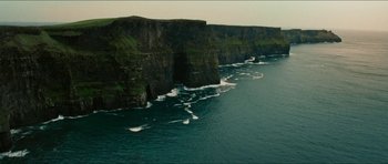 Movie still from “Cave Rescue” (2022), directed by Tom Waller – A view of the cliffs of moher from the ocean; Extreme Wide shot, High angle