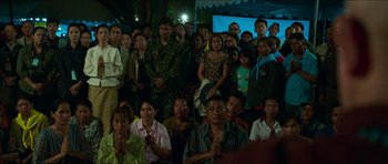 Movie still from “Cave Rescue” (2022), directed by Tom Waller – A large group of people gathered together for an event; Wide shot, High angle