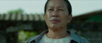 Movie still from “Cave Rescue” (2022), directed by Tom Waller – An older woman is looking into the distance; Close Up shot, Low angle