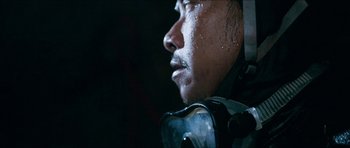 Movie still from “Cave Rescue” (2022), directed by Tom Waller – A person wearing a helmet; Extreme Close Up shot, Low angle