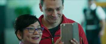 Movie still from “Cave Rescue” (2022), directed by Tom Waller – A man and a woman looking at a cell phone; Close Up shot, Low angle
