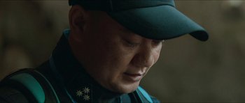 Movie still from “Cave Rescue” (2022), directed by Tom Waller – A person wearing a hat; Close Up shot, Low angle