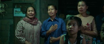 Movie still from “Cave Rescue” (2022), directed by Tom Waller – A group of women standing next to each other; Medium shot, Over the shoulder angle