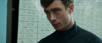 Movie still from “Cave Rescue” (2022), directed by Tom Waller – A person wearing a black shirt; Close Up shot, Low angle