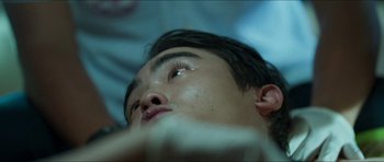 Movie still from “Cave Rescue” (2022), directed by Tom Waller – A young man's eyes and face; Extreme Close Up shot, Overhead angle