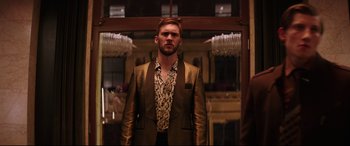Movie still from “Fast & Furious Presents: Hobbs & Shaw” (2019), directed by David Leitch – A man in a gold jacket standing in front of a mirror; Medium shot, Low angle