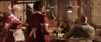 Movie still from “Fast & Furious Presents: Hobbs & Shaw” (2019), directed by David Leitch – Two women sitting at a table in a restaurant; Medium shot, Over the shoulder angle