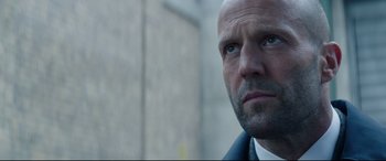 Movie still from “Fast & Furious Presents: Hobbs & Shaw” (2019), directed by David Leitch – A man with a bald head looking at the camera; Close Up shot, Low angle