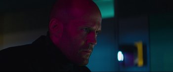 Movie still from “Fast & Furious Presents: Hobbs & Shaw” (2019), directed by David Leitch – A man with a bald head looking to his left; Close Up shot, Low angle