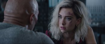 Movie still from “Fast & Furious Presents: Hobbs & Shaw” (2019), directed by David Leitch – A young woman with white hair and blue eyes looking into the camera; Close Up shot, Over the shoulder angle
