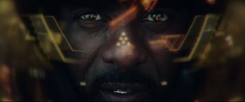 Movie still from “Fast & Furious Presents: Hobbs & Shaw” (2019), directed by David Leitch – A man's face with triangles in the background; Extreme Close Up shot, Overhead angle