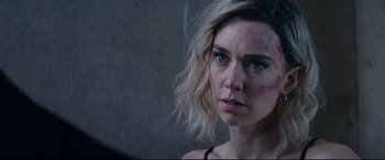 Movie still from “Fast & Furious Presents: Hobbs & Shaw” (2019), directed by David Leitch – A person wearing a black shirt; Close Up shot, Over the shoulder angle