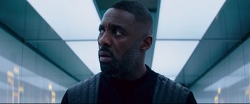 Movie still from “Fast & Furious Presents: Hobbs & Shaw” (2019), directed by David Leitch – A man with a beard looking to his left; Close Up shot, Low angle