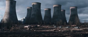 Movie still from “Fast & Furious Presents: Hobbs & Shaw” (2019), directed by David Leitch – A group of large cooling towers sitting on top of a field; Extreme Wide shot, High angle