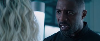 Movie still from “Fast & Furious Presents: Hobbs & Shaw” (2019), directed by David Leitch – A person with a beard; Close Up shot, Over the shoulder angle