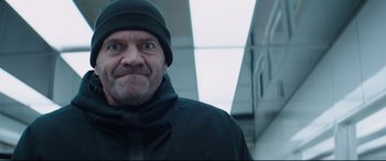 Movie still from “Fast & Furious Presents: Hobbs & Shaw” (2019), directed by David Leitch – A person wearing a jacket and a hat; Close Up shot, Low angle