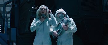 Movie still from “Fast & Furious Presents: Hobbs & Shaw” (2019), directed by David Leitch – Two people in white coats and a gas mask; Medium shot, Low angle