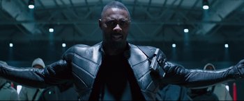 Movie still from “Fast & Furious Presents: Hobbs & Shaw” (2019), directed by David Leitch – A man with a gun in his hand and wearing a leather jacket; Close Up shot, Low angle