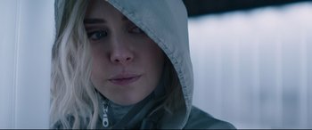 Movie still from “Fast & Furious Presents: Hobbs & Shaw” (2019), directed by David Leitch – A person wearing a hooded jacket; Close Up shot, Over the shoulder angle