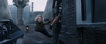 Movie still from “Fast & Furious Presents: Hobbs & Shaw” (2019), directed by David Leitch – A woman in a green shirt is falling off of a train; Wide shot, Low angle