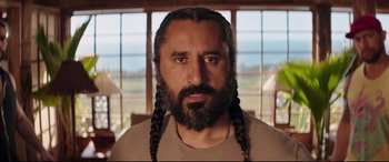 Movie still from “Fast & Furious Presents: Hobbs & Shaw” (2019), directed by David Leitch – A man with long hair and a beard; Close Up shot, Low angle