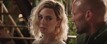 Movie still from “Fast & Furious Presents: Hobbs & Shaw” (2019), directed by David Leitch – A woman with blonde curly hair is looking at a man; Close Up shot, Over the shoulder angle
