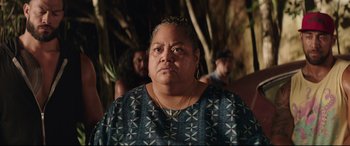 Movie still from “Fast & Furious Presents: Hobbs & Shaw” (2019), directed by David Leitch – An older woman is looking at the camera; Close Up shot, Over the shoulder angle