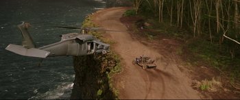 Movie still from “Fast & Furious Presents: Hobbs & Shaw” (2019), directed by David Leitch – A helicopter is flying over a truck on a dirt road; Extreme Wide shot, High angle