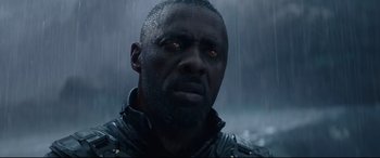 Movie still from “Fast & Furious Presents: Hobbs & Shaw” (2019), directed by David Leitch – A man with a black jacket on in the rain; Close Up shot, Low angle