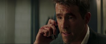 Movie still from “Fast & Furious Presents: Hobbs & Shaw” (2019), directed by David Leitch – A person talking on a cell phone; Close Up shot, Over the shoulder angle