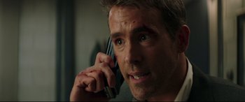 Movie still from “Fast & Furious Presents: Hobbs & Shaw” (2019), directed by David Leitch – A person talking on a cell phone; Close Up shot, Over the shoulder angle