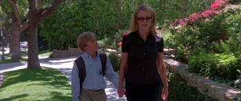 Movie still from “Cellular” (2004), directed by David R. Ellis – A woman and a young boy walking down a sidewalk; Medium shot, Over the shoulder angle