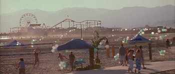 Movie still from “Cellular” (2004), directed by David R. Ellis – A group of people standing on top of a sandy beach; Extreme Wide shot, High angle