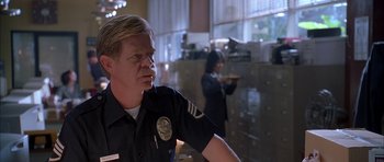 Movie still from “Cellular” (2004), directed by David R. Ellis – A police officer is standing next to a woman; Close Up shot, Low angle