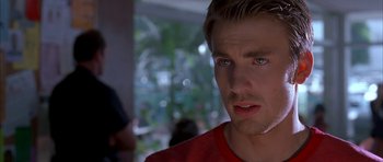 Movie still from “Cellular” (2004), directed by David R. Ellis – A person wearing a red shirt; Close Up shot, Over the shoulder angle