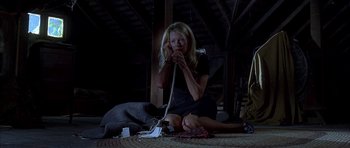 Movie still from “Cellular” (2004), directed by David R. Ellis – A woman sitting on the ground talking on a phone; Wide shot, Low angle