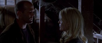 Movie still from “Cellular” (2004), directed by David R. Ellis – A man and a woman are talking in a dark room; Close Up shot, Low angle