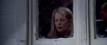 Movie still from “Cellular” (2004), directed by David R. Ellis – A woman looking out of a window at night; Close Up shot, Low angle