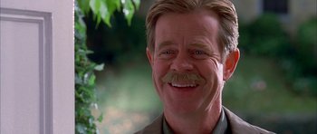 Movie still from “Cellular” (2004), directed by David R. Ellis – A person with a mustache smiling; Close Up shot, Over the shoulder angle