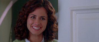 Movie still from “Cellular” (2004), directed by David R. Ellis – A woman smiling for the camera; Close Up shot, Over the shoulder angle